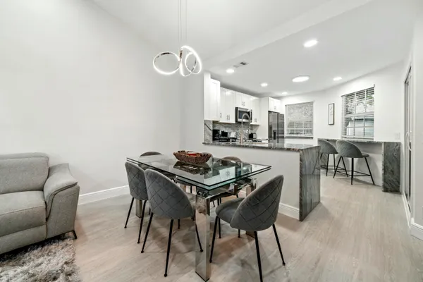 a dining room with furniture and wooden floor