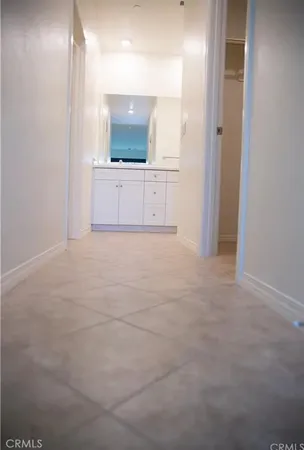 a view of a kitchen with a sink and a mirror
