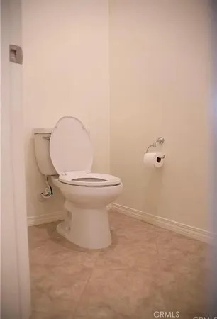 a bathroom with a toilet and a mirror