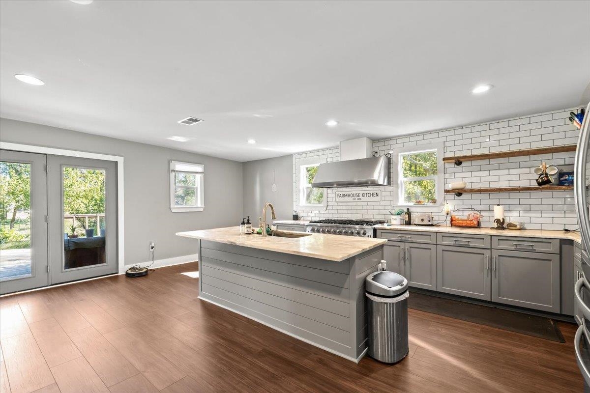 9301 Osborn Road Arlington, TN 38002 - Photo 12 of 31 a kitchen with sink stove and wooden floor