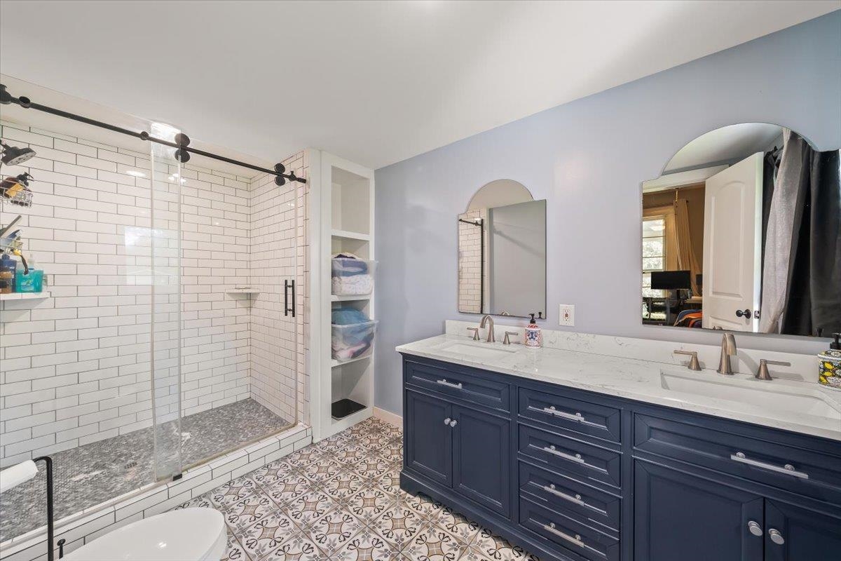 9301 Osborn Road Arlington, TN 38002 - Photo 14 of 31 a bathroom with a granite countertop sink mirror and shower