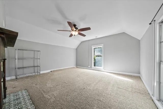 a bathroom with a granite countertop toilet sink and mirror