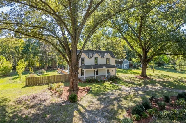 a front view of a house with a garden and porch