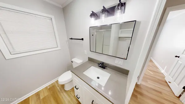 a bathroom with a sink a mirror and a toilet