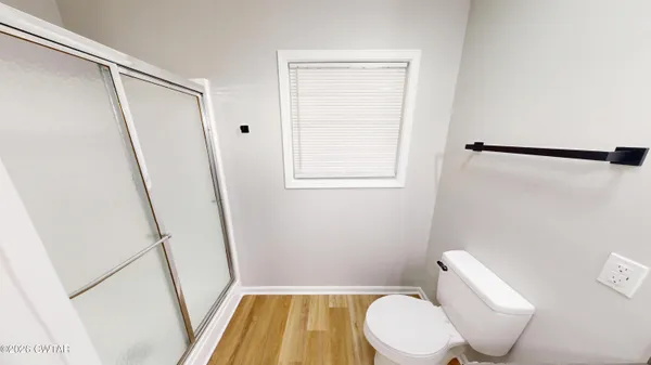 a white toilet sitting next to a small sink