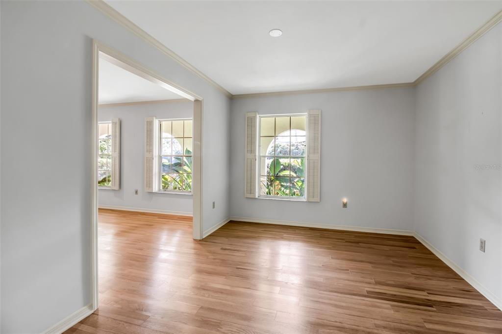 509 Spoonbill Way Sarasota, FL 34236 - Photo 11 of 86 an empty room with wooden floor and windows
