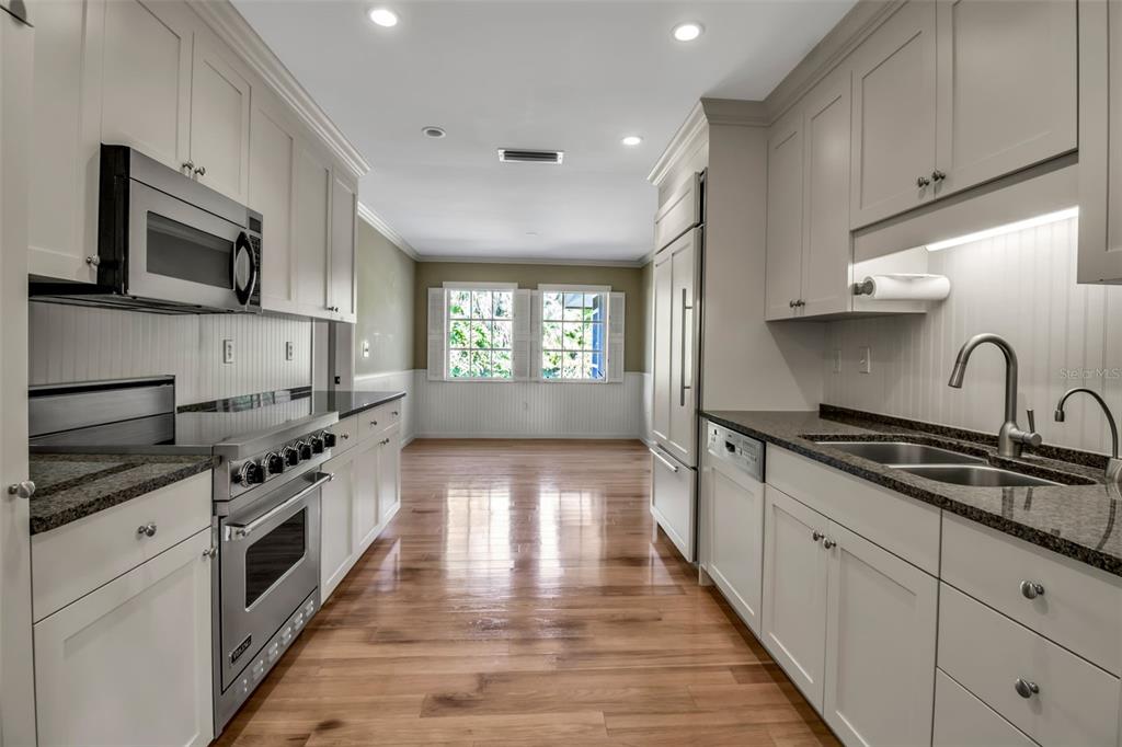 509 Spoonbill Way Sarasota, FL 34236 - Photo 14 of 86 a kitchen with stainless steel appliances granite countertop a stove a sink and a microwave