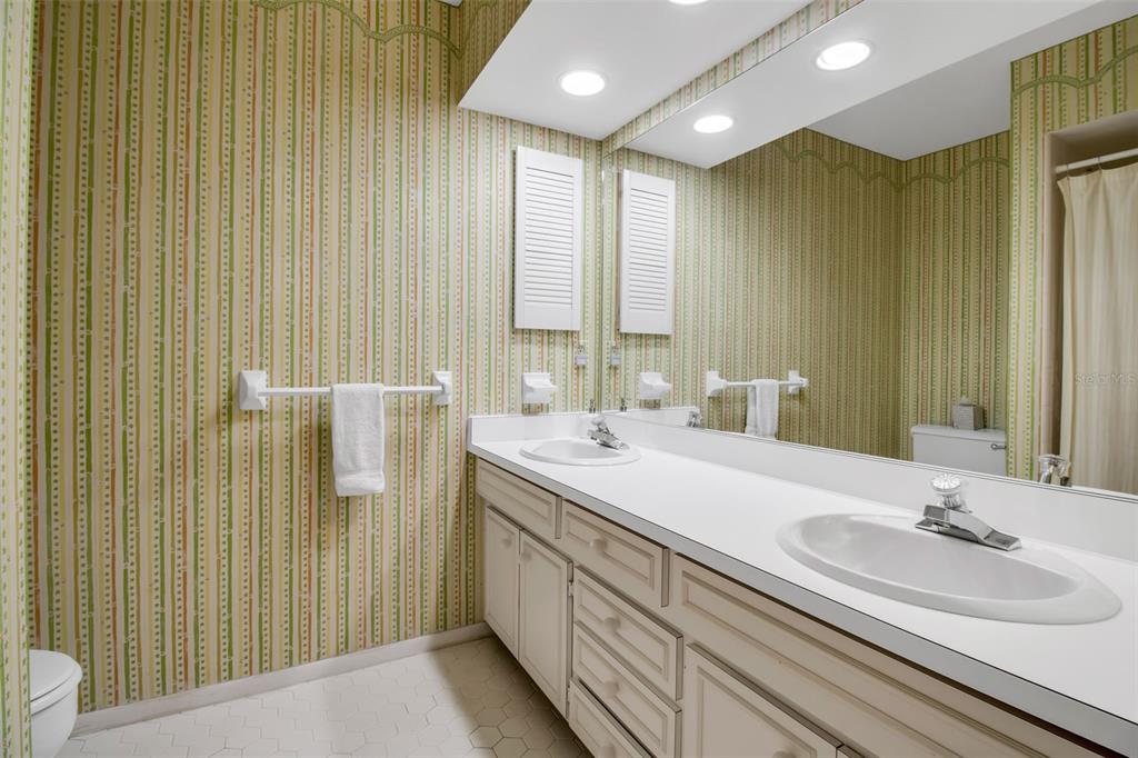 509 Spoonbill Way Sarasota, FL 34236 - Photo 33 of 86 a bathroom with a double vanity sink a mirror and a shower