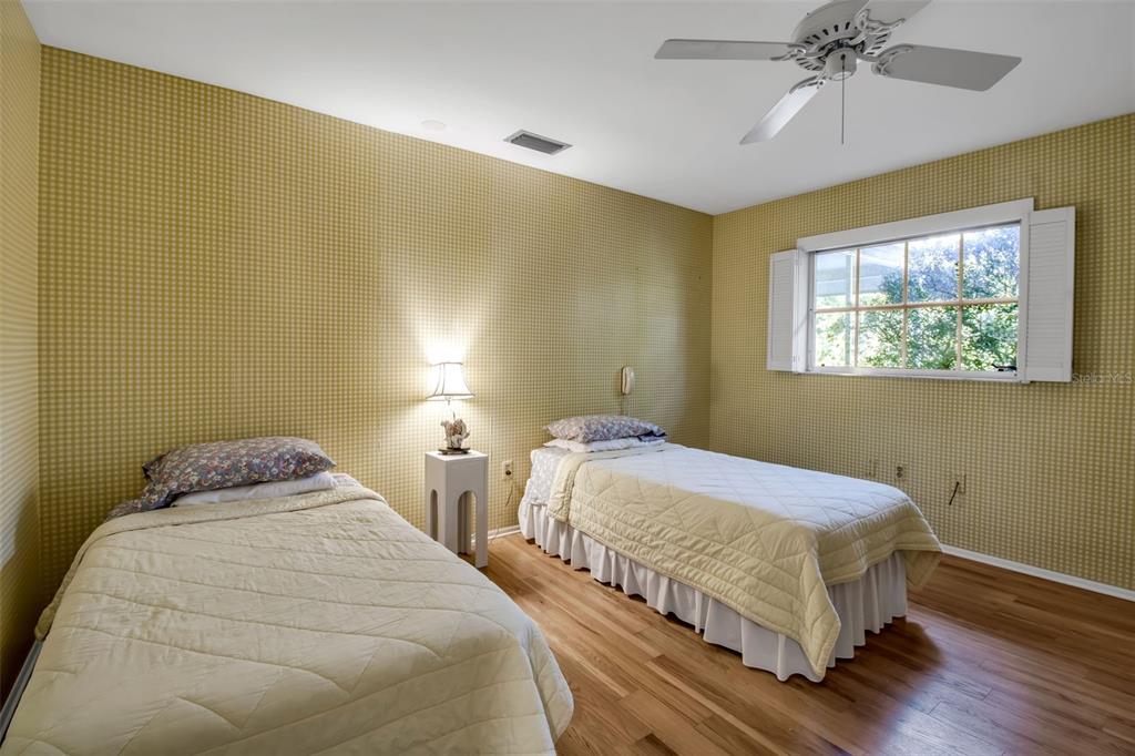 509 Spoonbill Way Sarasota, FL 34236 - Photo 36 of 86 a bedroom with two beds and a chandelier