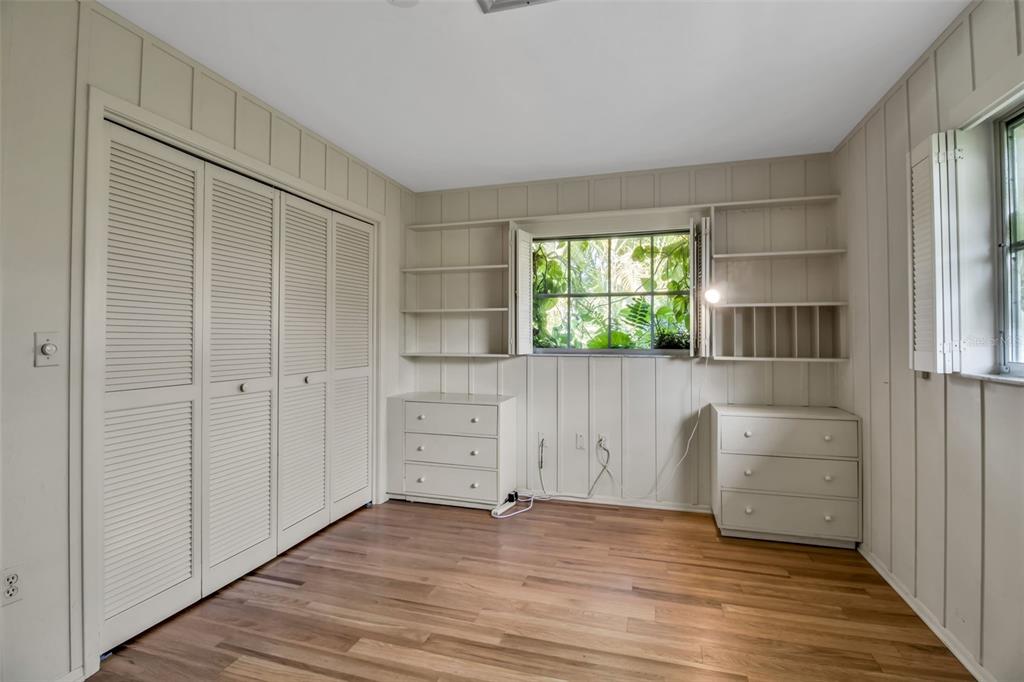 509 Spoonbill Way Sarasota, FL 34236 - Photo 40 of 86 a view of an empty room with wooden floor and a window