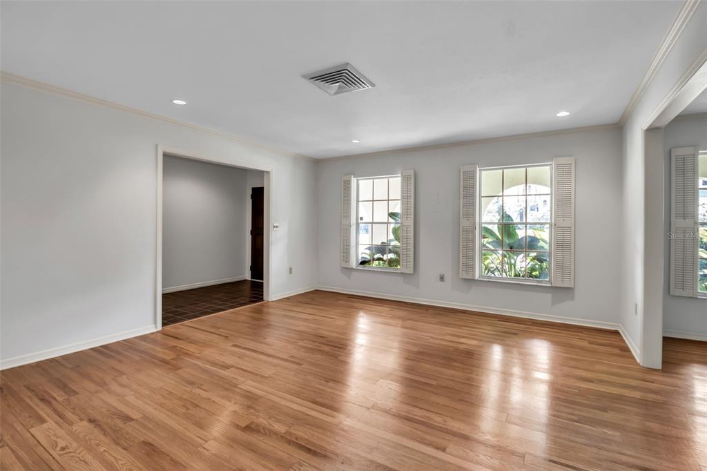 509 Spoonbill Way Sarasota, FL 34236 - Photo 9 of 86 an empty room with wooden floor and windows