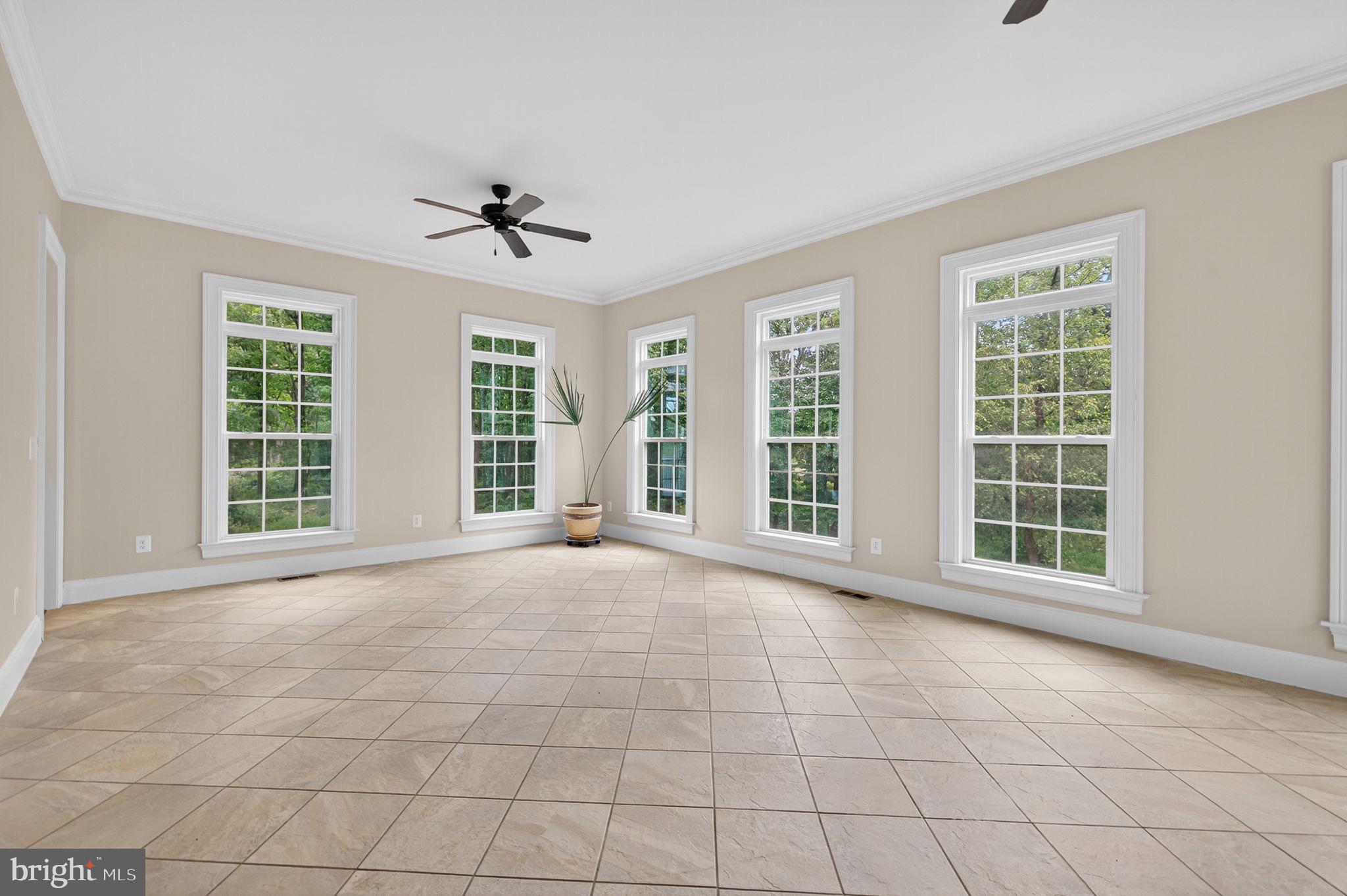 22011 Beaverdam Drive Ashburn, VA 20148 - Photo 105 of 106 an empty room with windows and chandelier fan