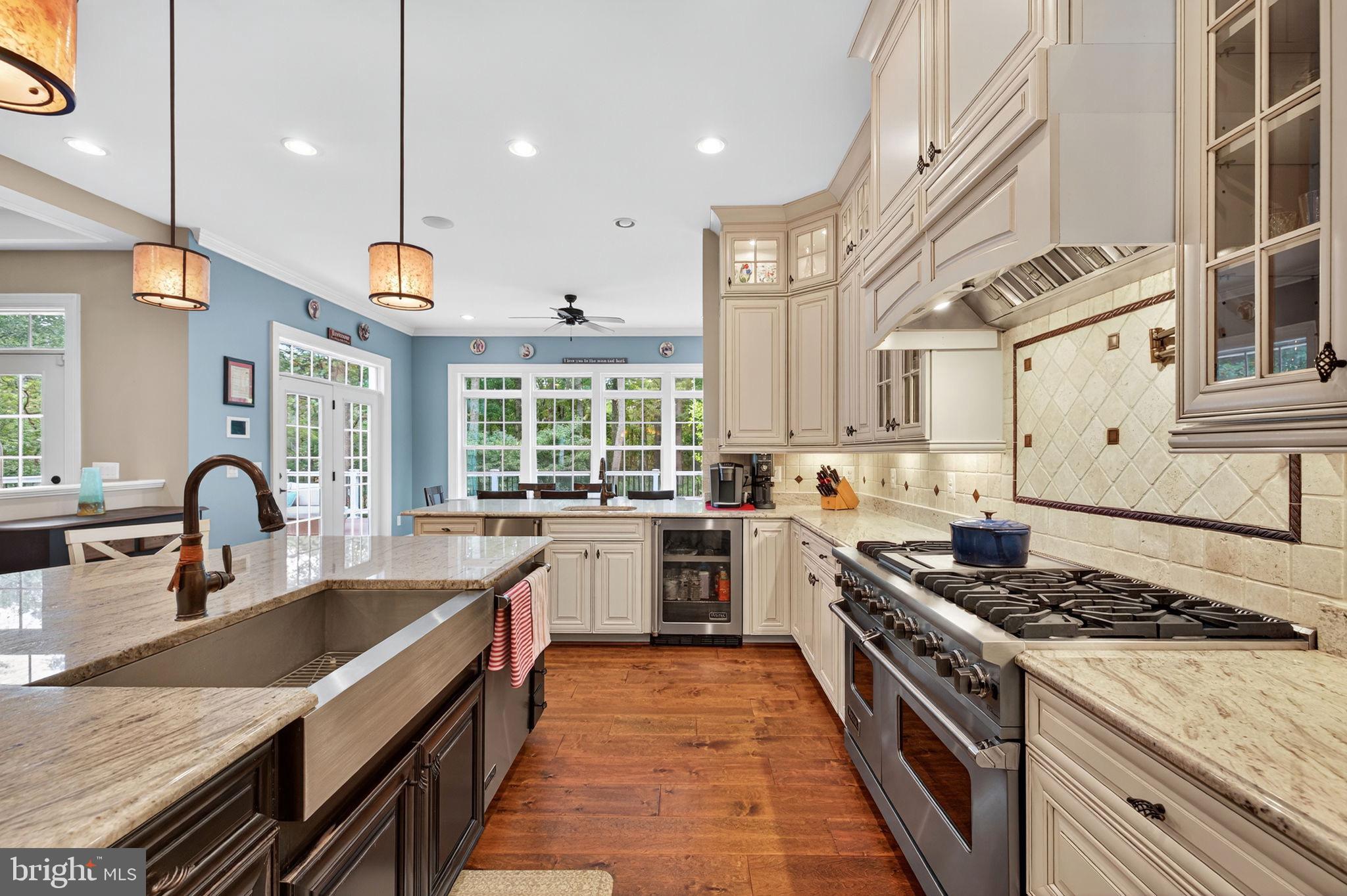 22011 Beaverdam Drive Ashburn, VA 20148 - Photo 31 of 106 a large kitchen with stainless steel appliances granite countertop a lot of counter space and a sink