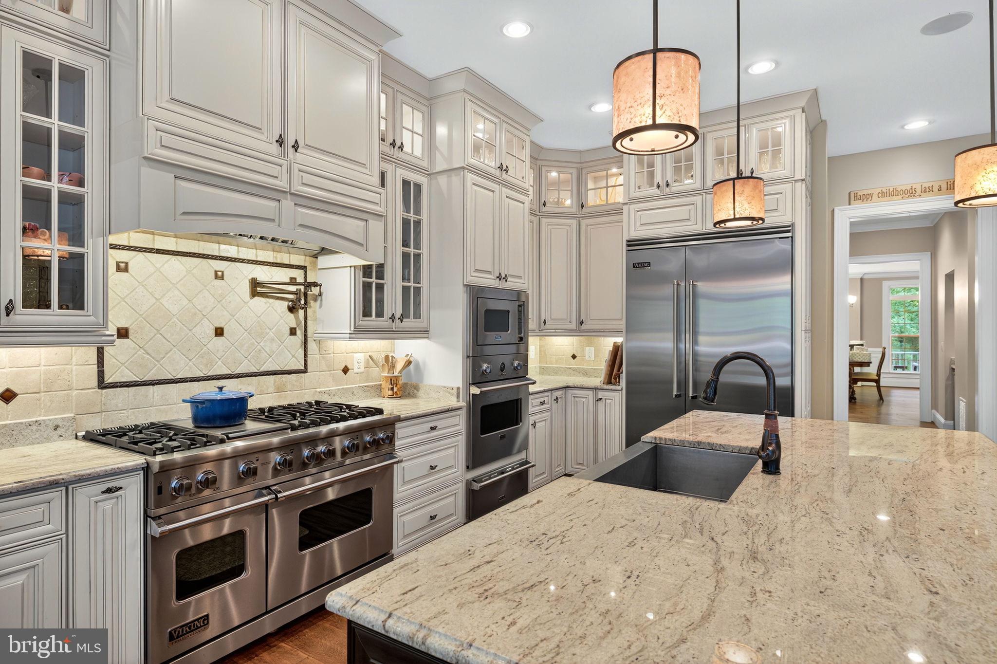 22011 Beaverdam Drive Ashburn, VA 20148 - Photo 35 of 106 a kitchen with stainless steel appliances granite countertop a stove a sink and a refrigerator