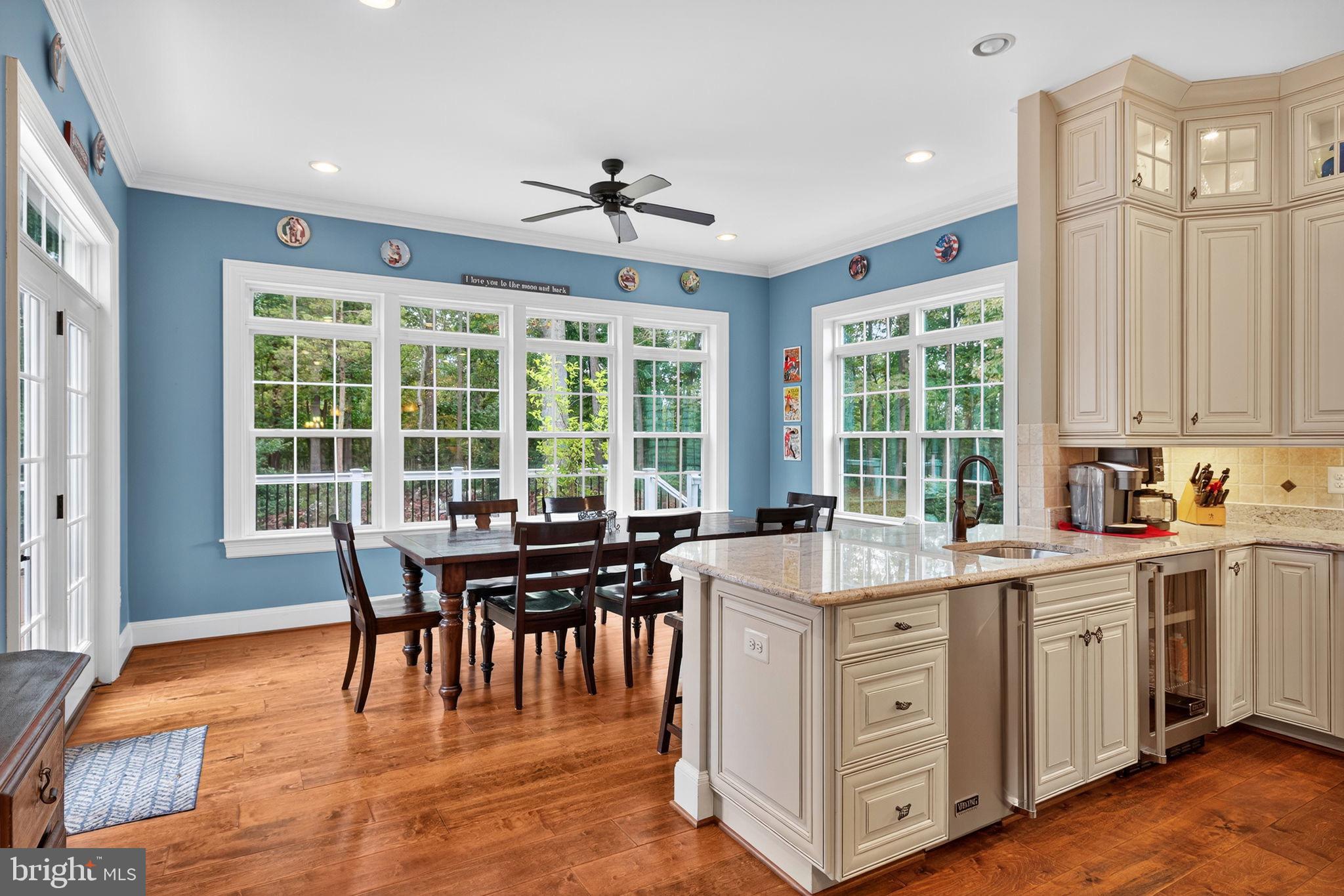 22011 Beaverdam Drive Ashburn, VA 20148 - Photo 36 of 106 a view of a kitchen with granite countertop a dining table chairs and stainless steel appliances