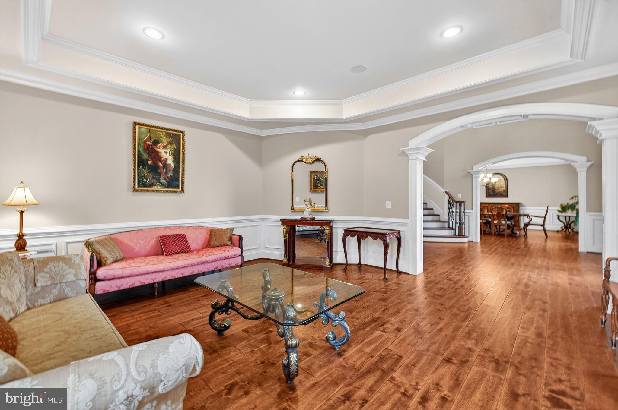 22011 Beaverdam Drive Ashburn, VA 20148 - Photo 45 of 106 a living room with furniture and a dining table with wooden floor