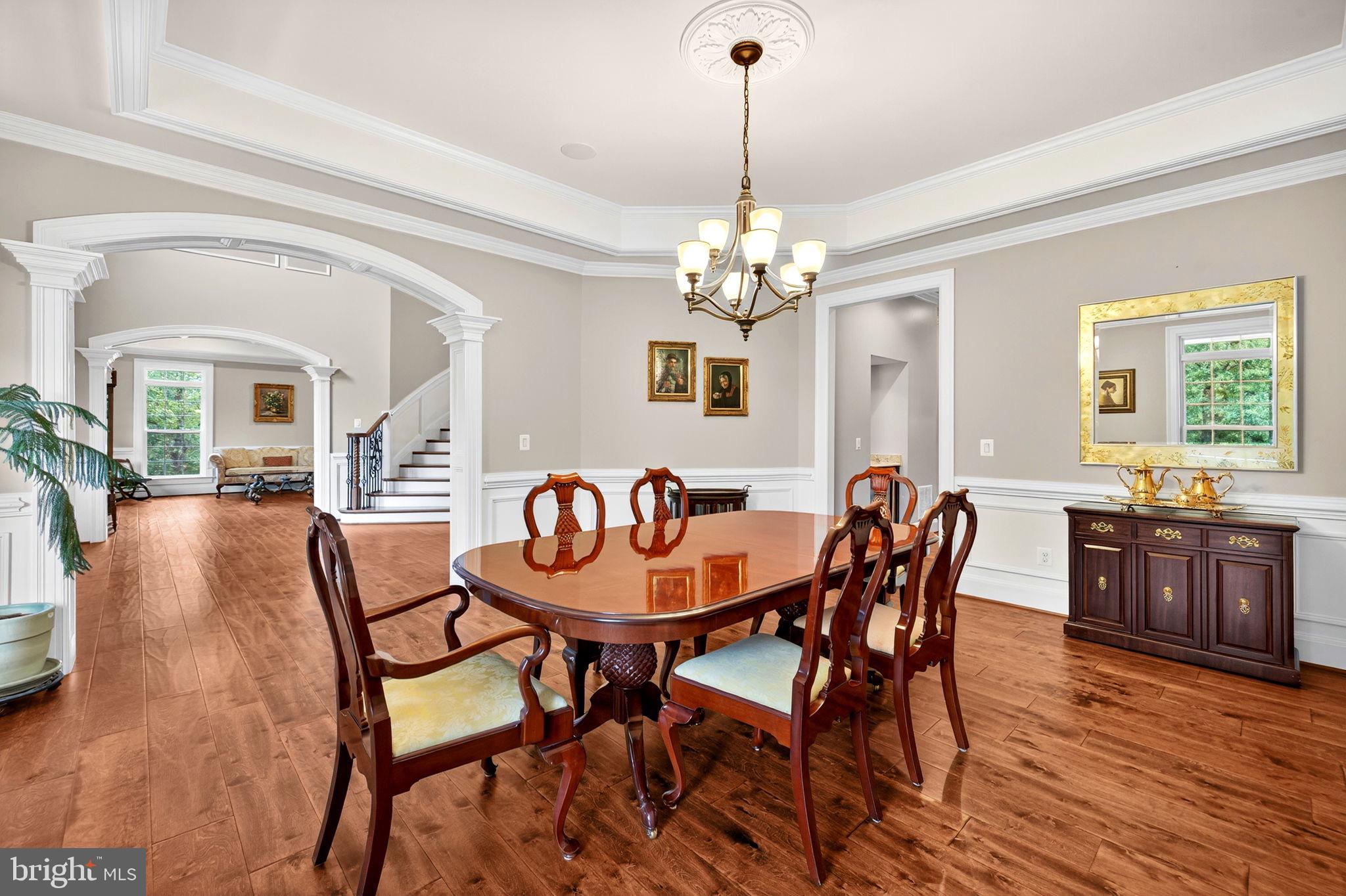 22011 Beaverdam Drive Ashburn, VA 20148 - Photo 48 of 106 a dining room with furniture a chandelier and wooden floor