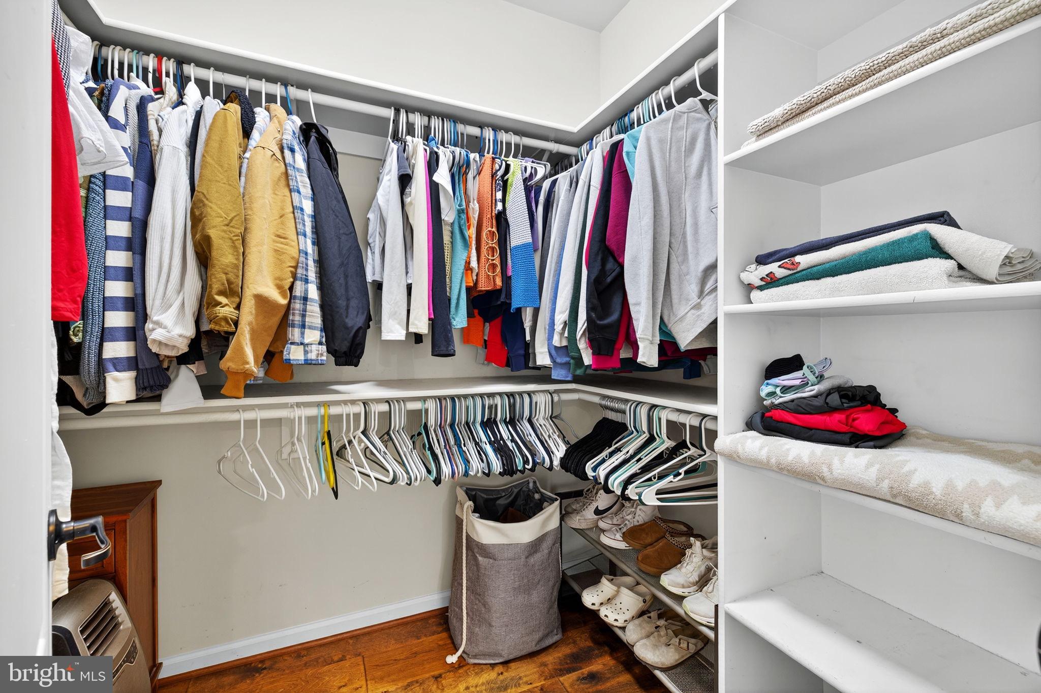 22011 Beaverdam Drive Ashburn, VA 20148 - Photo 65 of 106 a view of walk in closet with clothes and shoes