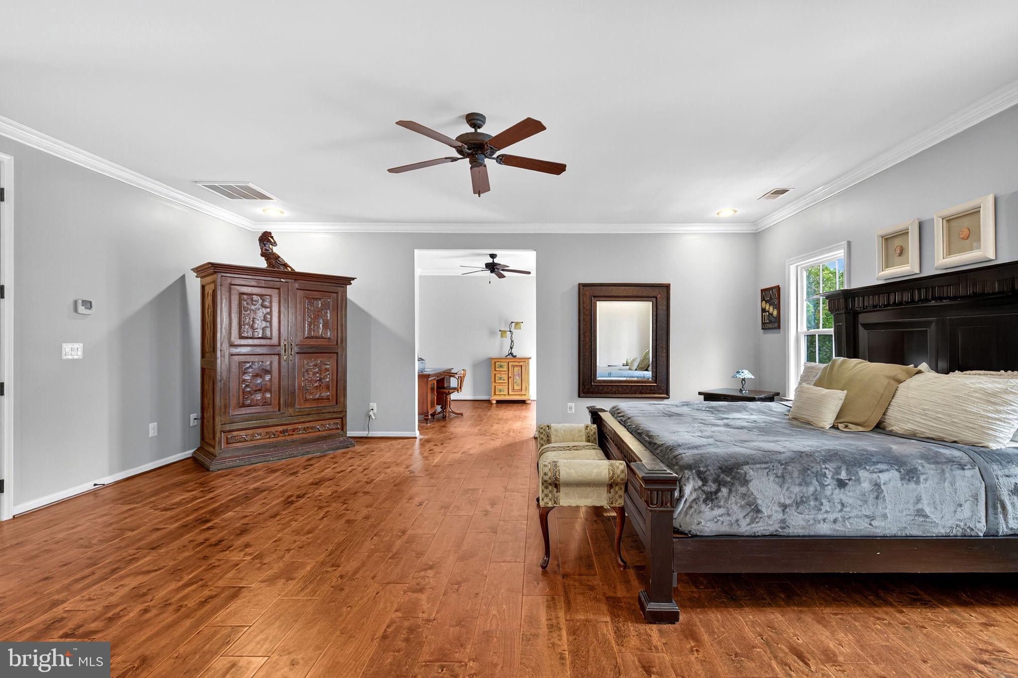 22011 Beaverdam Drive Ashburn, VA 20148 - Photo 75 of 106 a bedroom with a bed and wooden floor