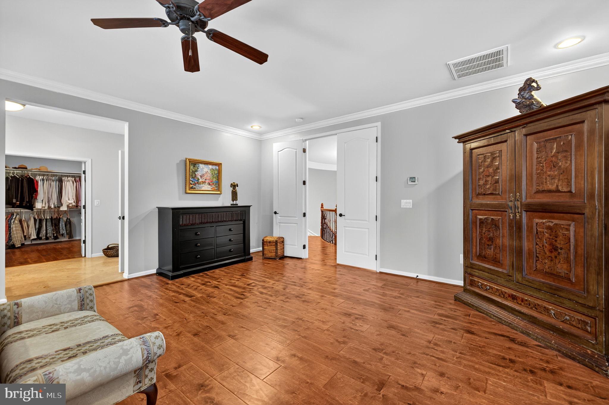 22011 Beaverdam Drive Ashburn, VA 20148 - Photo 78 of 106 a living room with furniture a ceiling fan and a wooden floor