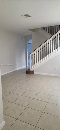 a view of staircase with white walls