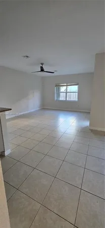 a kitchen with stainless steel appliances kitchen island granite countertop a sink and white cabinets