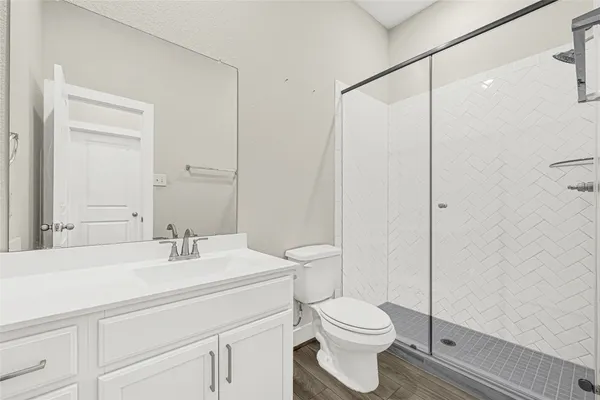 a bathroom with a sink toilet and a mirror