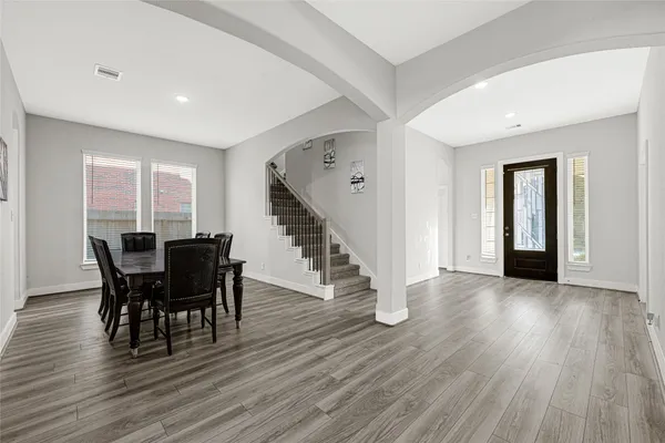 a view of a dining room with furniture and wooden floor