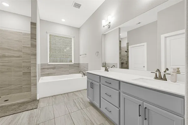 a white bath tub sitting in a bathroom next to a window