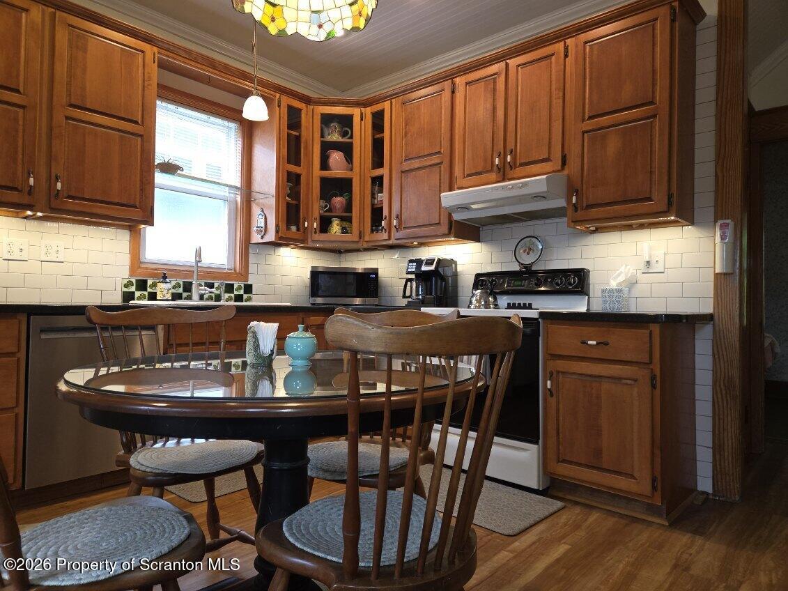 229 East Mountain Road Scranton, PA 18505 - Photo 21 of 47 a kitchen with granite countertop a table chairs stove and cabinets