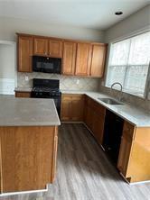 520 Hammersmith Drive Suwanee, GA 30024 - Photo 2 of 12 a kitchen with a sink a stove and microwave