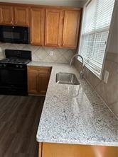 520 Hammersmith Drive Suwanee, GA 30024 - Photo 3 of 12 a kitchen with granite countertop a sink a stove and a microwave