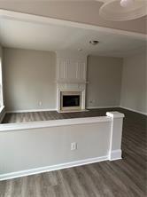 520 Hammersmith Drive Suwanee, GA 30024 - Photo 5 of 12 a view of an empty room with wooden floor and a fireplace