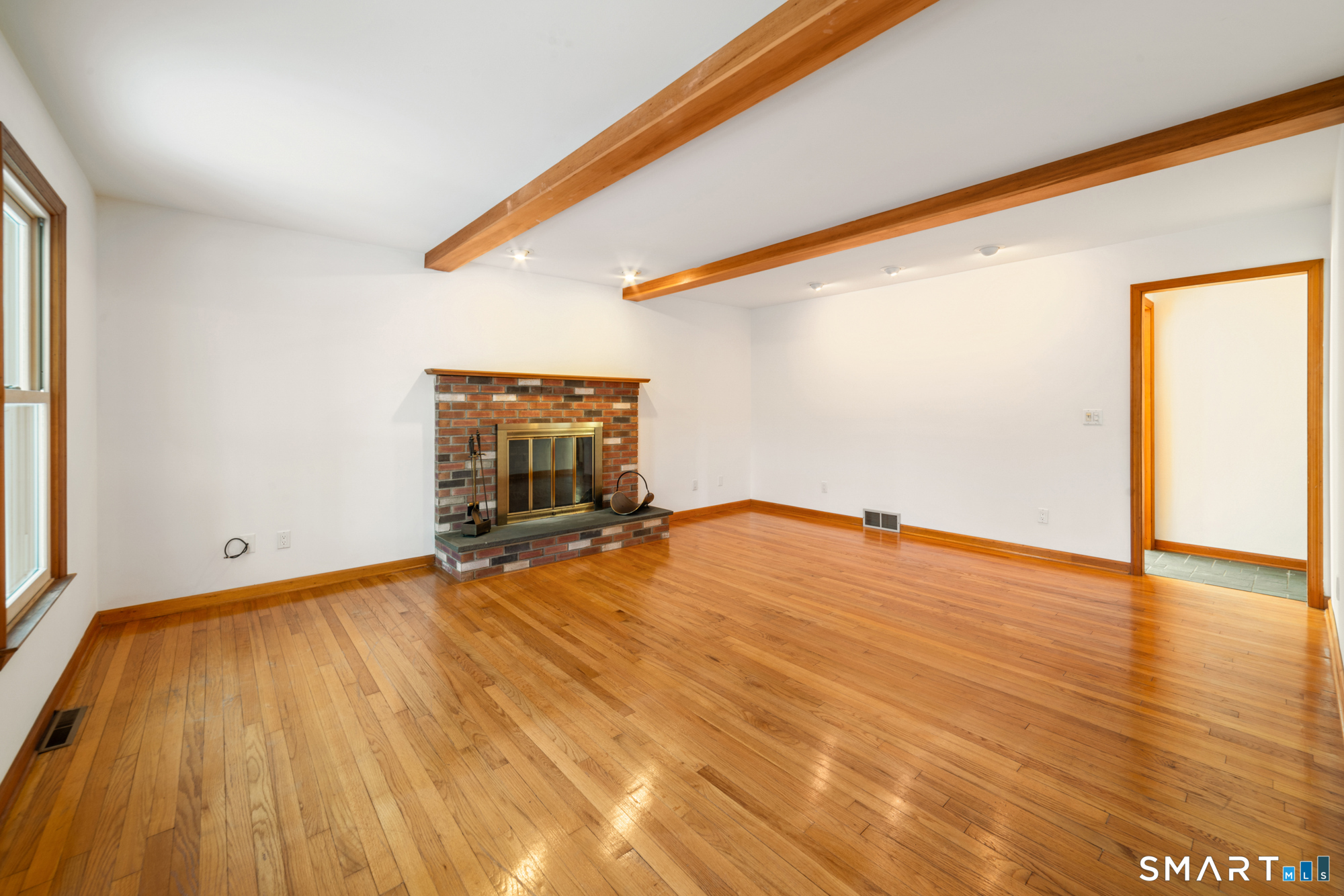 672 Old Waterbury Road Southbury, CT 06488 - Photo 13 of 38 Spacious living room with hardwood floor and fireplace