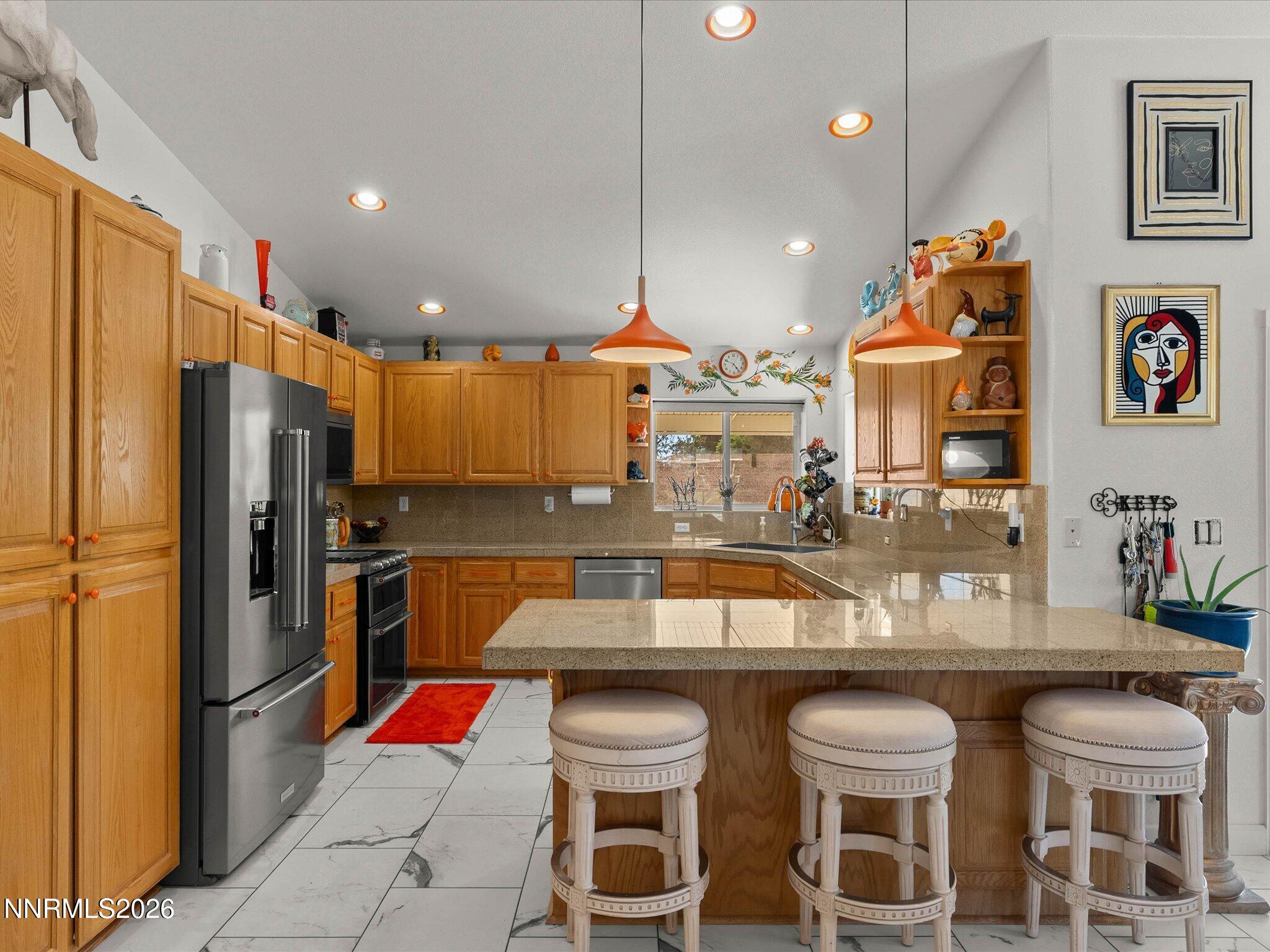 1080 Red Rock Road Fernley, NV 89408 - Photo 16 of 45 a kitchen with a table chairs and a refrigerator