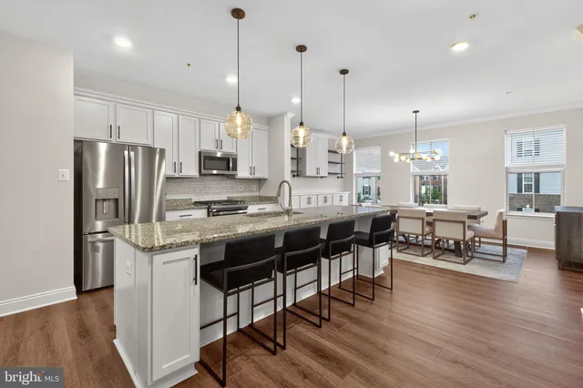 a kitchen with stainless steel appliances a refrigerator stove and microwave