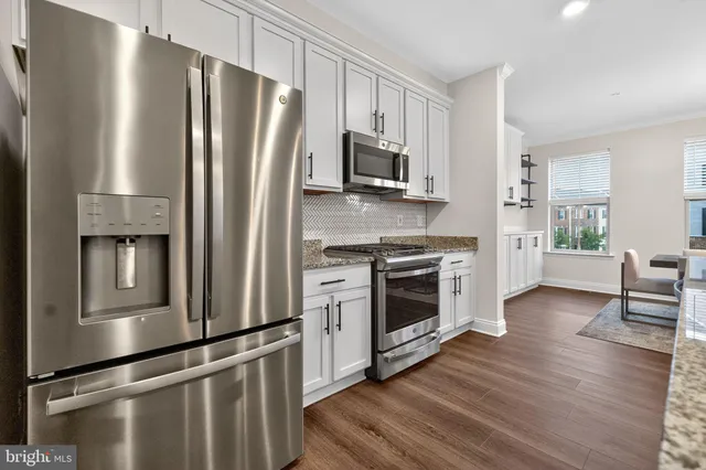 a kitchen with sink refrigerator and microwave