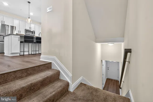 a view of a kitchen with wooden floor and electronic appliances