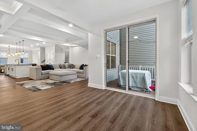 a living room with furniture window and a wooden floor