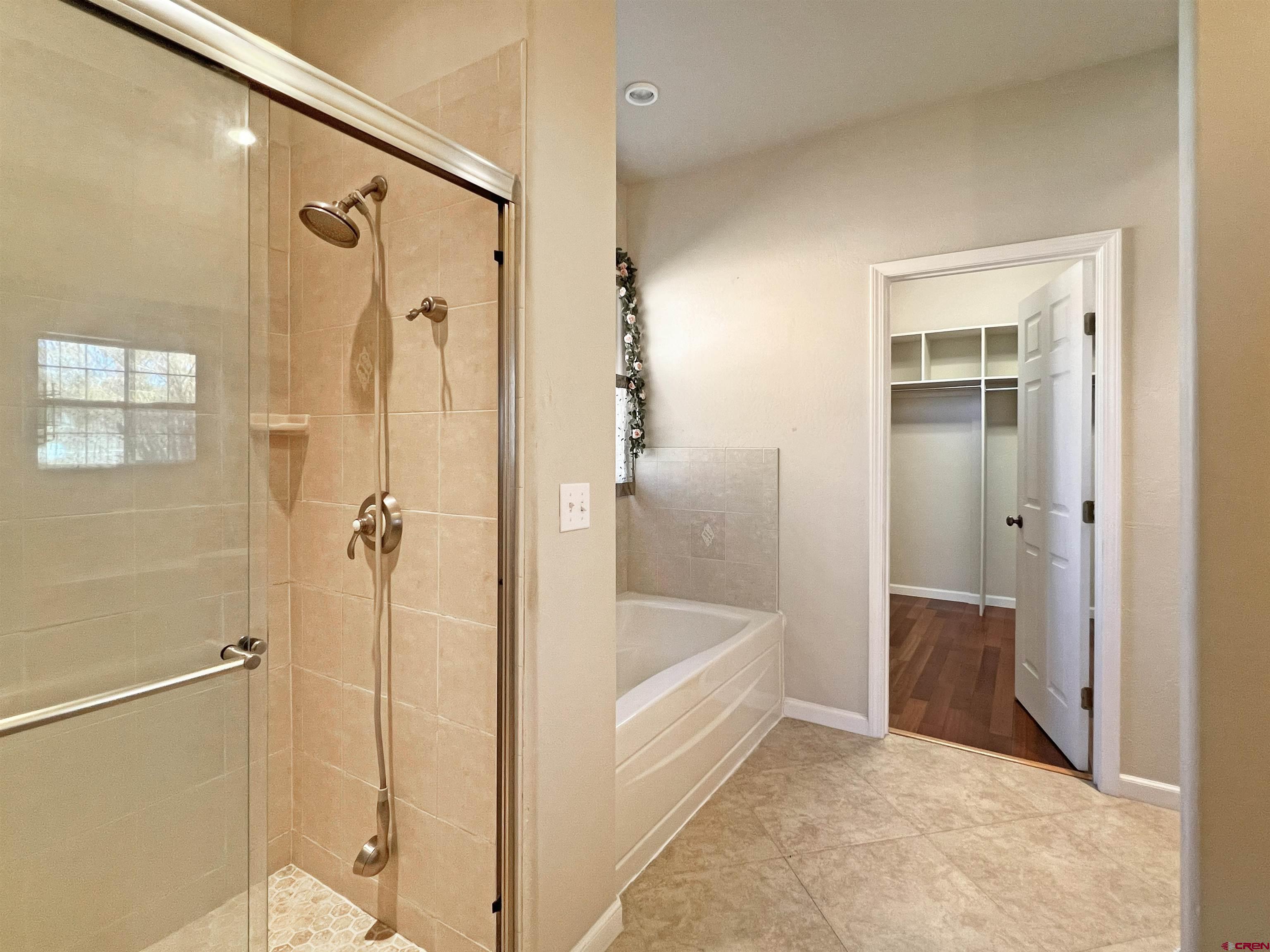 13723 Road 23 Cortez, CO 81321 - Photo 12 of 45 a bathroom with a bathtub and a shower