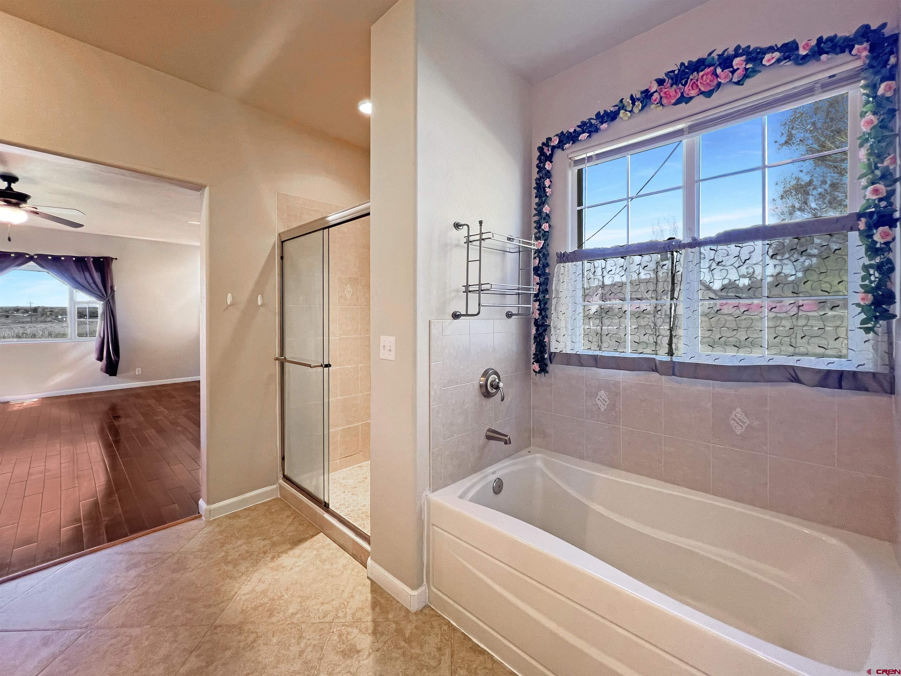13723 Road 23 Cortez, CO 81321 - Photo 14 of 45 a spacious bathroom with a tub and shower