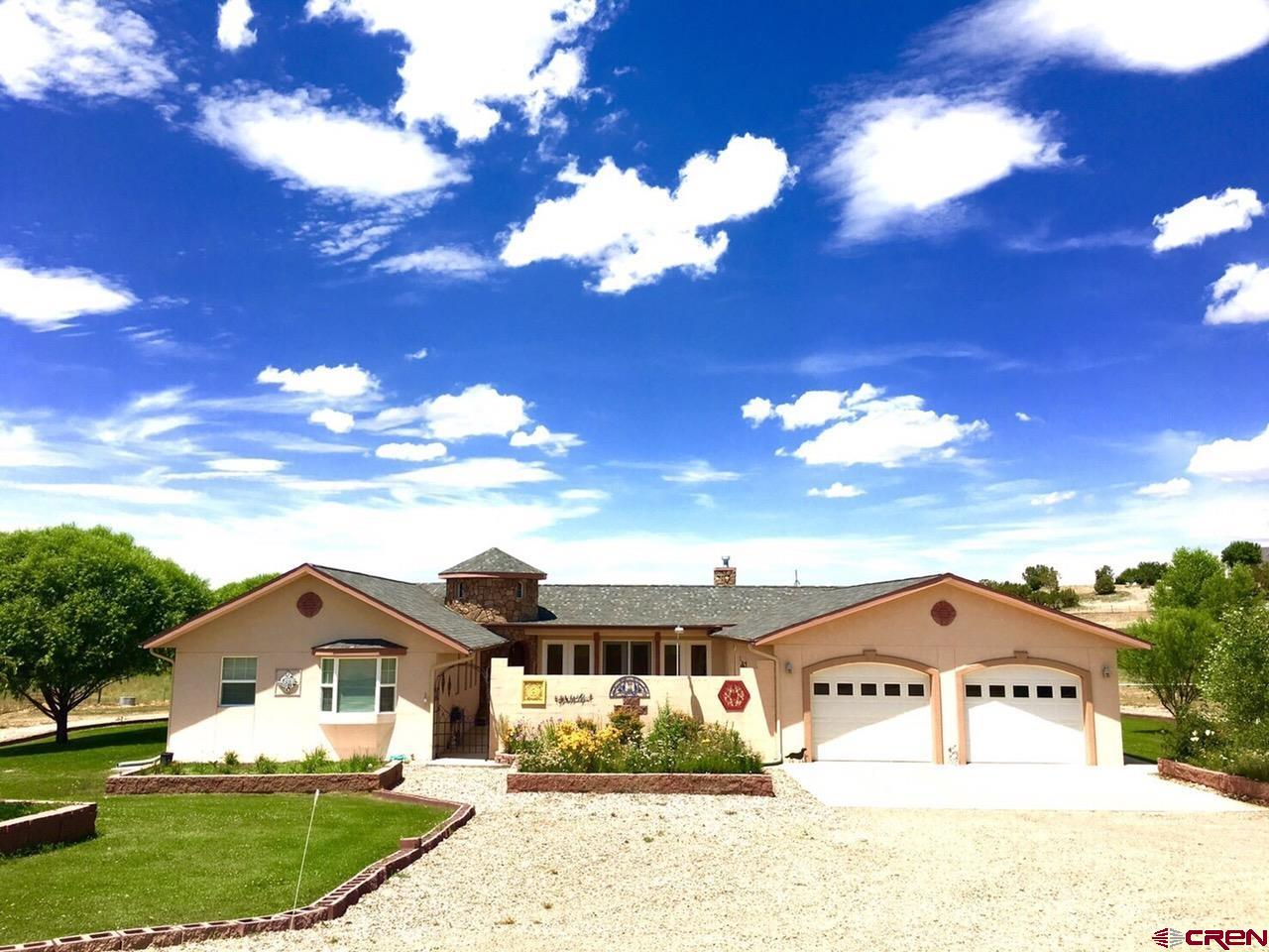 13723 Road 23 Cortez, CO 81321 - Photo 17 of 45 a view of a white house with a yard