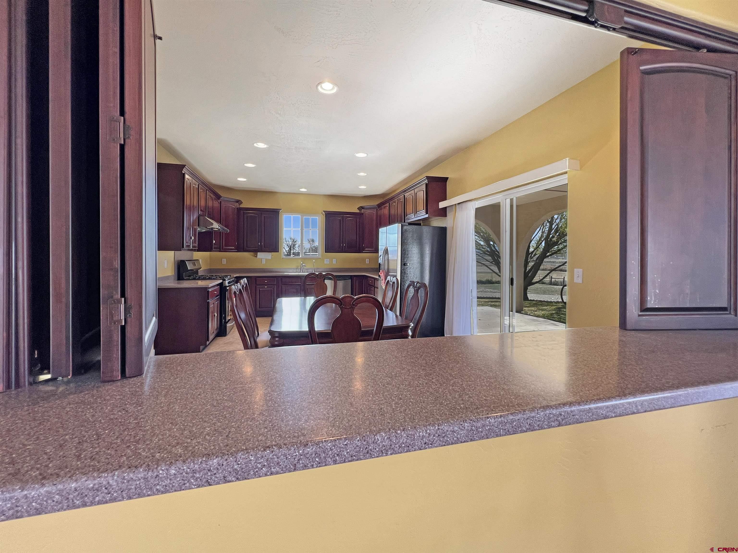 13723 Road 23 Cortez, CO 81321 - Photo 22 of 45 a view of a living room with kitchen island furniture and a kitchen view