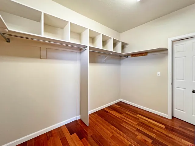 a view of a room with wooden floor