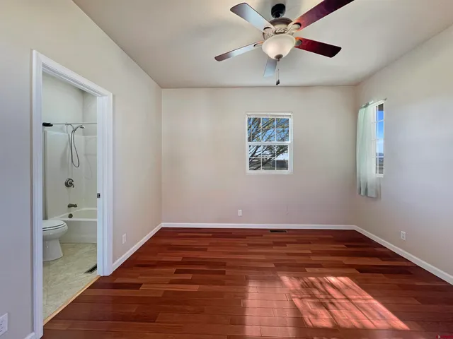 a view of an empty room and bathroom