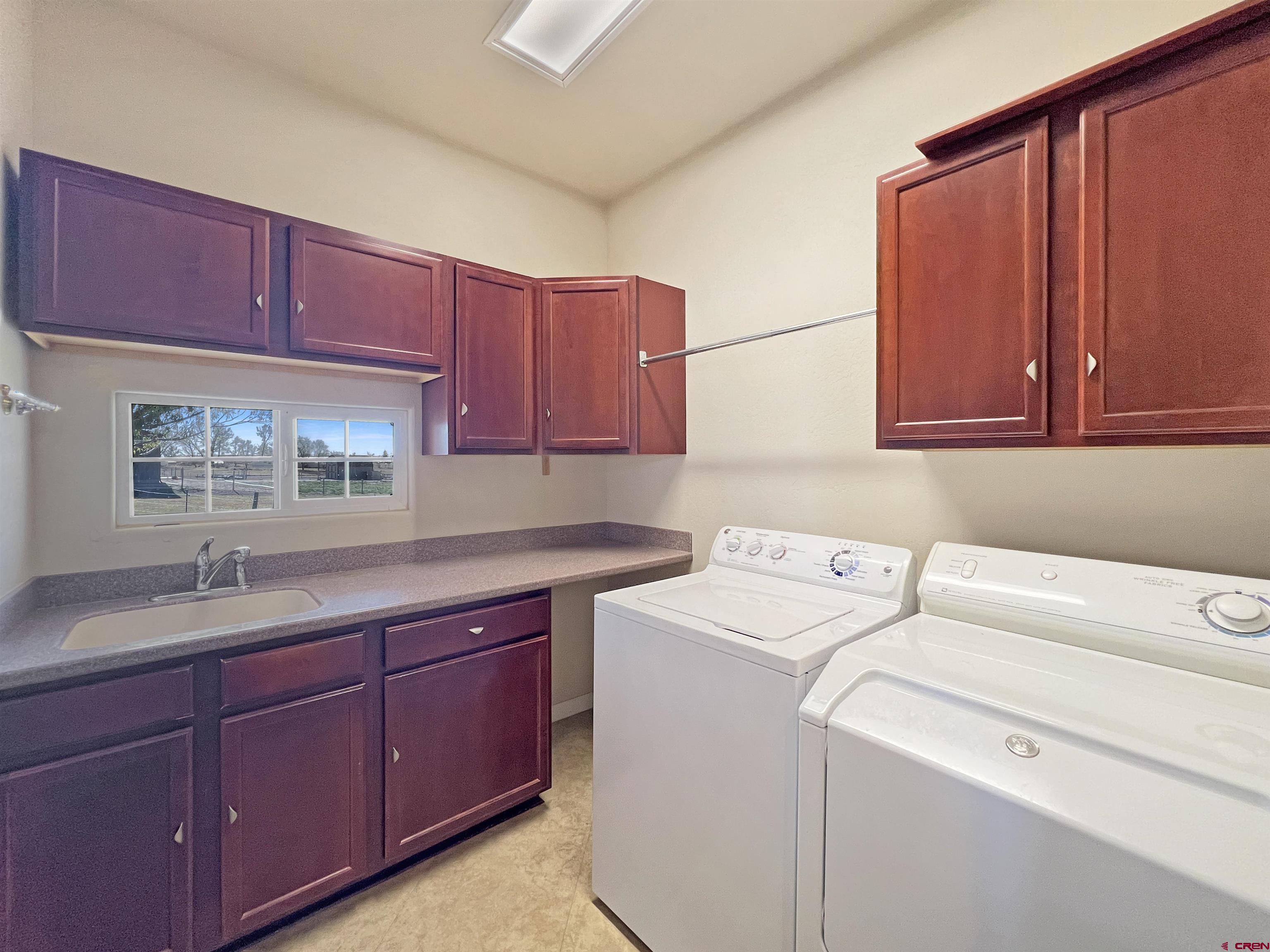13723 Road 23 Cortez, CO 81321 - Photo 32 of 45 a utility room with sink dryer and washer