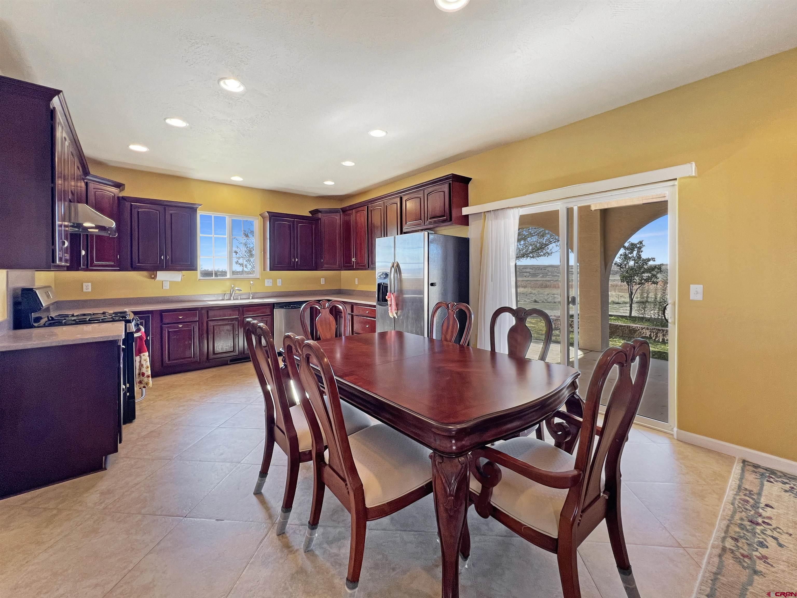 13723 Road 23 Cortez, CO 81321 - Photo 6 of 45 a view of a dining room and livingroom with furniture a rug a kitchen and a chandelier