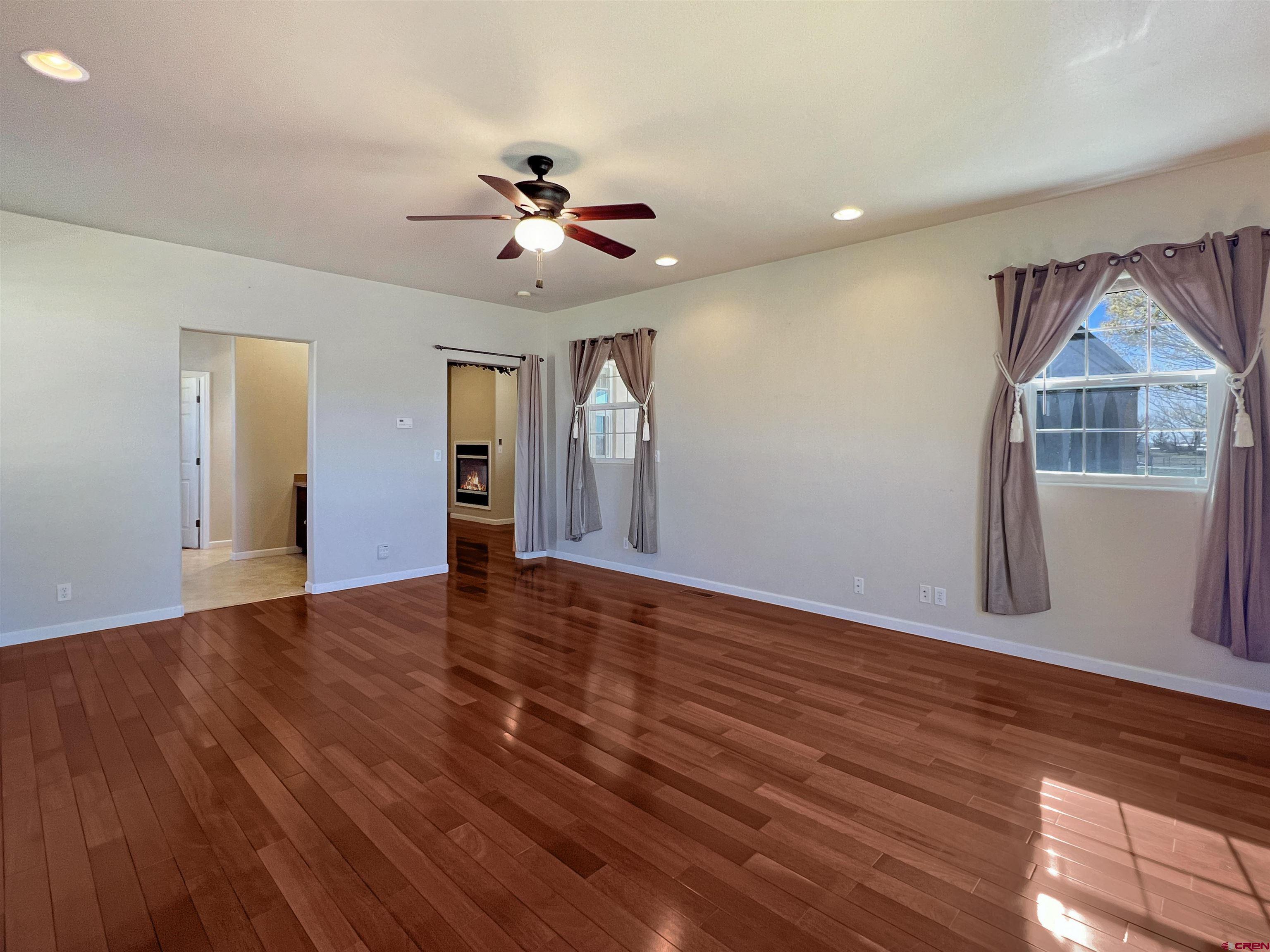 13723 Road 23 Cortez, CO 81321 - Photo 10 of 45 a view of an empty room with a window and wooden floor