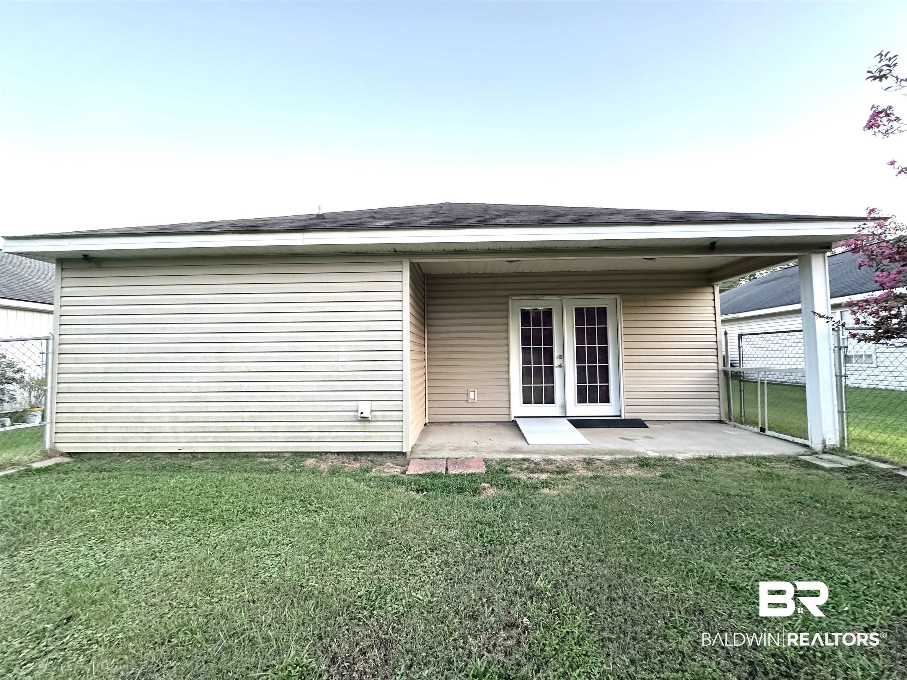 18975 Florida Street Robertsdale, AL 36567 - Photo 4 of 8 Back of property featuring french doors and a patio