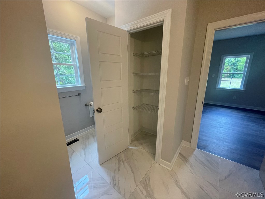 737 Rainbow Ridge Bumpass, VA 23024 - Photo 27 of 45 an empty room with wooden floor and a window